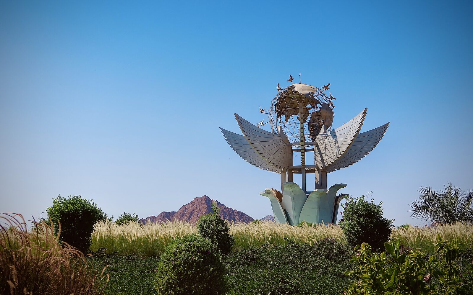 The landmark sculpture at the entrance to Sharm El Sheikh with the Sinai mountains behind