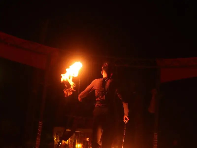 A fire spinner mid-routine at a Bedouin camp show.